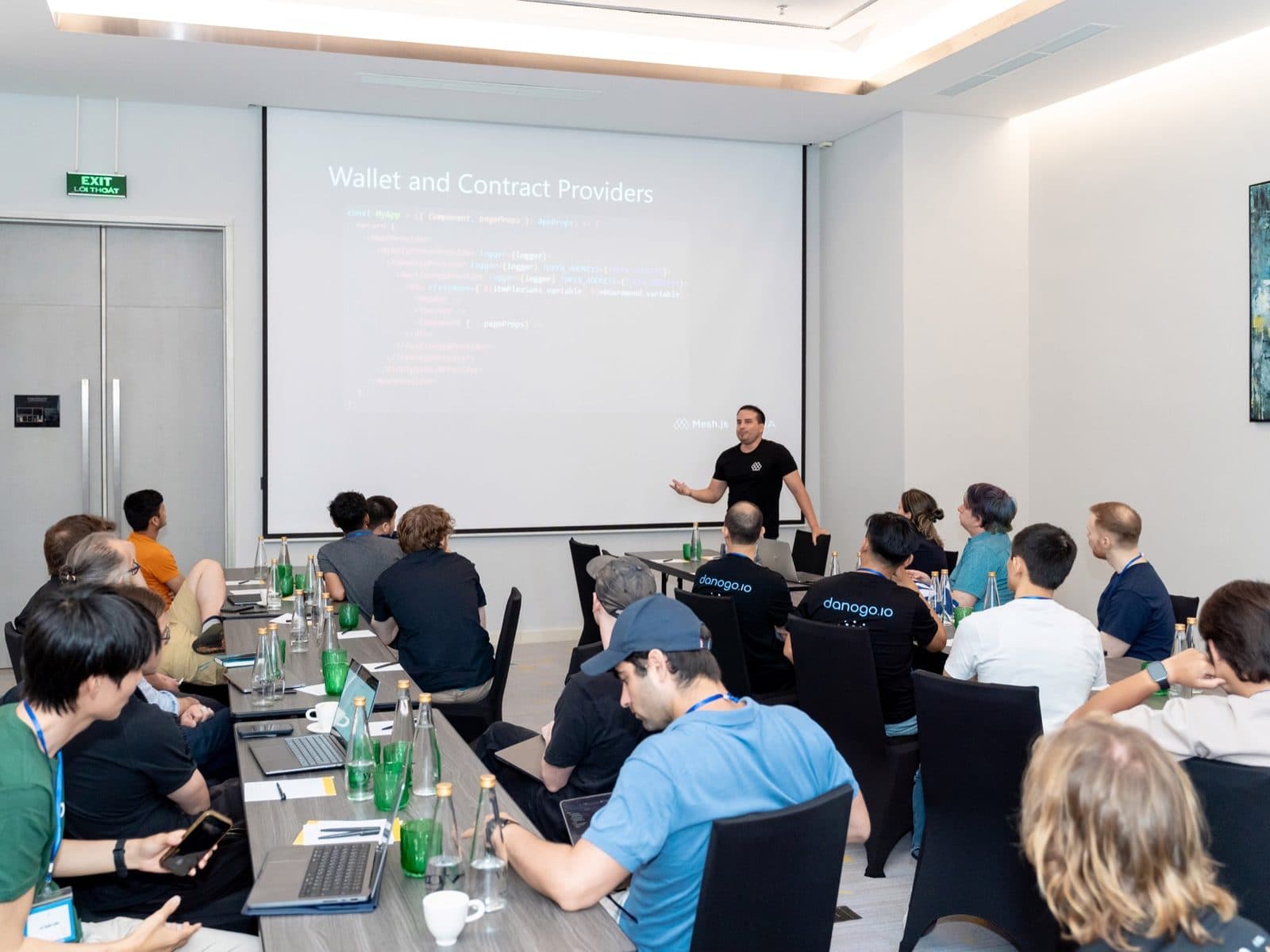 A workshop room in Da Nang, participants at laptops, a slide about wallet and contract providers on the screen.
